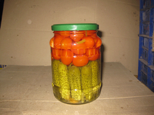 Assorted baby cucumber and chery tomatoes in jar
