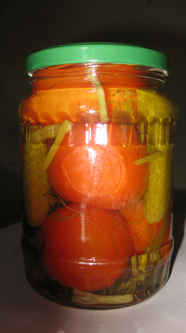 Pickled tomato and baby cucumber in jar